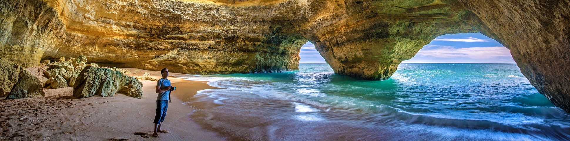 Hiker observing the stunning coastline of Algarve (Portugal)