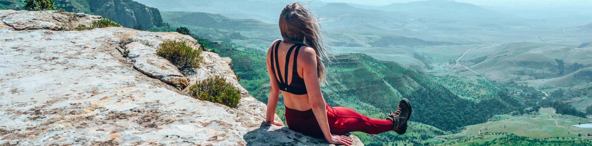 Girl sitting at the cliff in Drakensberg Mountains