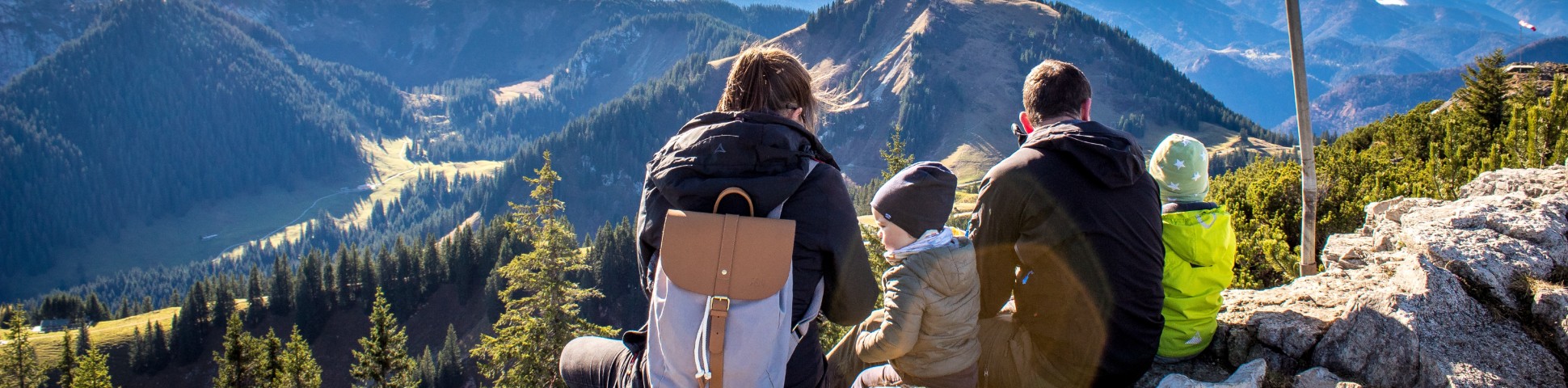 Parents with two children hiking in the mountains