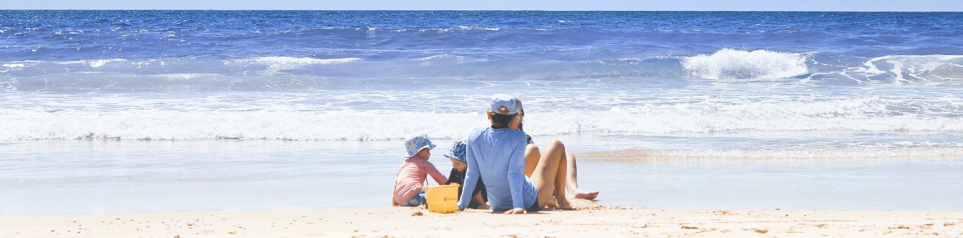 Family enjoying the sunny weather near the beach