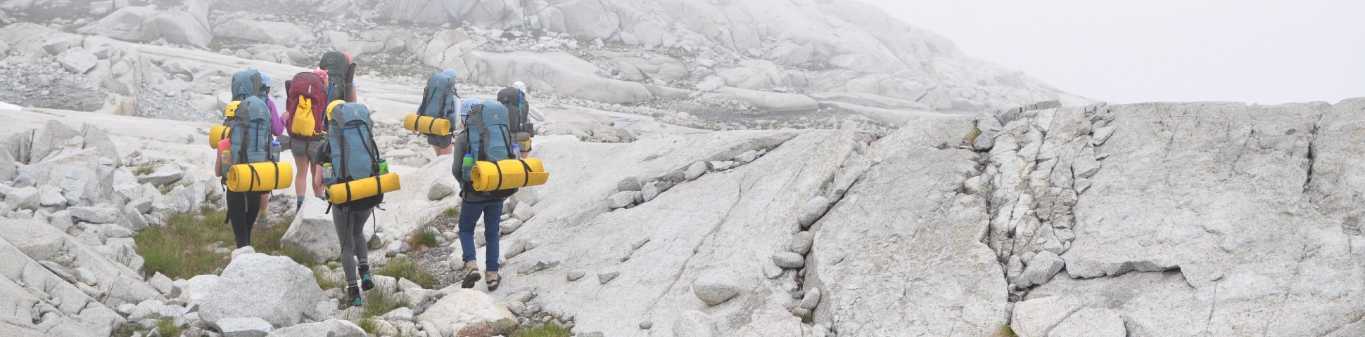 Group of trekkers walking in the rocky surroundings