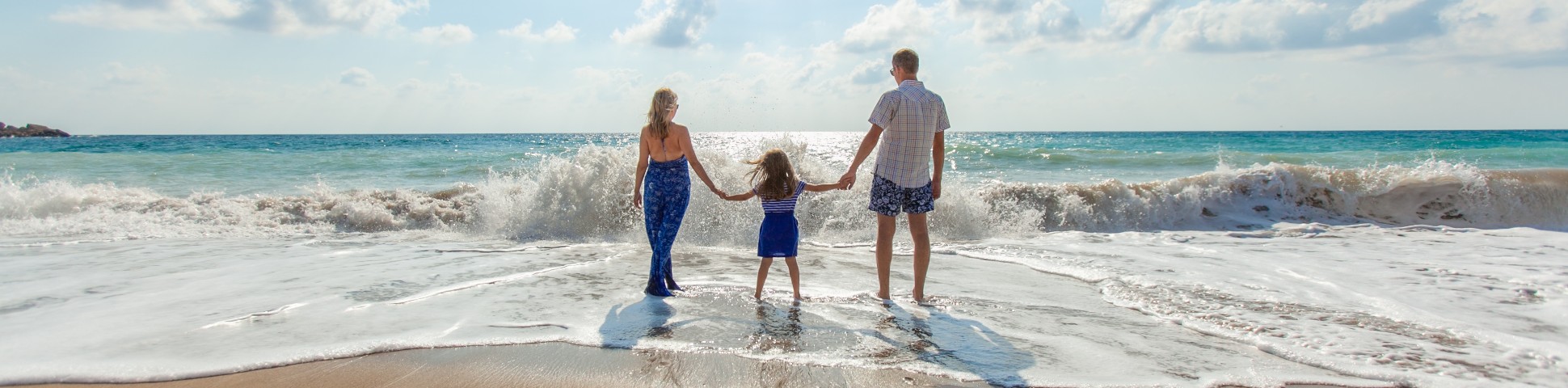 Family walking along the beach while on a guided tour