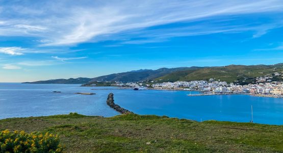 Blue sky over the cove and small village at Tinos island