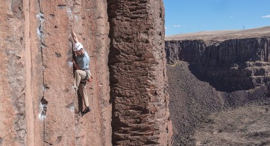 Climbing in red rock valley