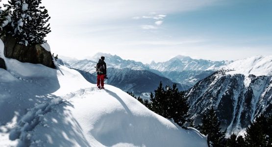 Hiker walking among snowed in mountains