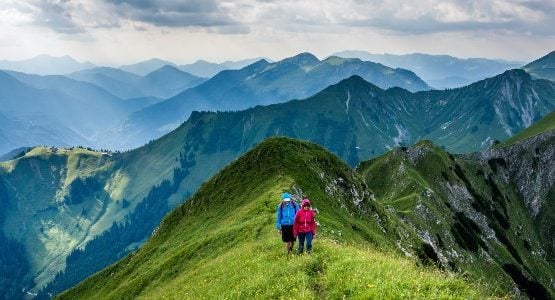 Two hikers walking on a ridge