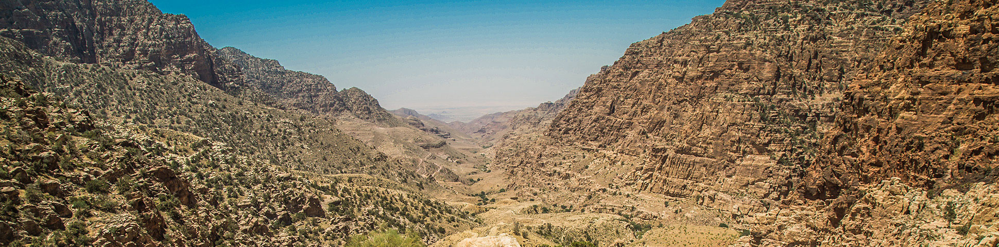 Panoramic view from expansive valley on guided trek from Dana to Petra in Jordan