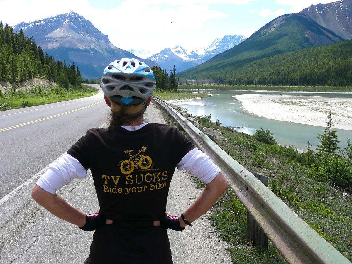 Posing in front of beautiful valley on guided cycling tour from Jasper to Banff in Canada