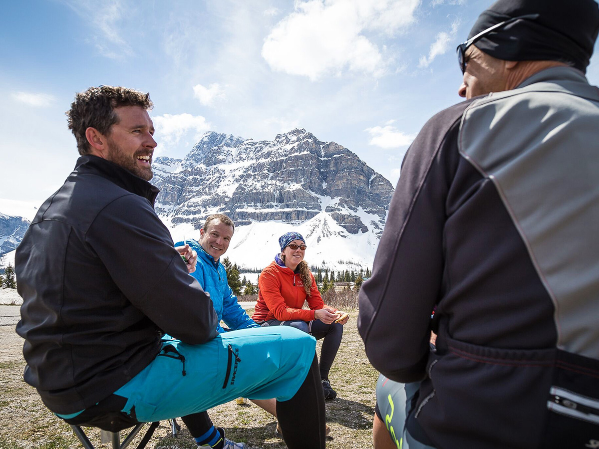 Bikers resting near Icefields Parkway on guided cycling tour from Jasper to Banff in Canada