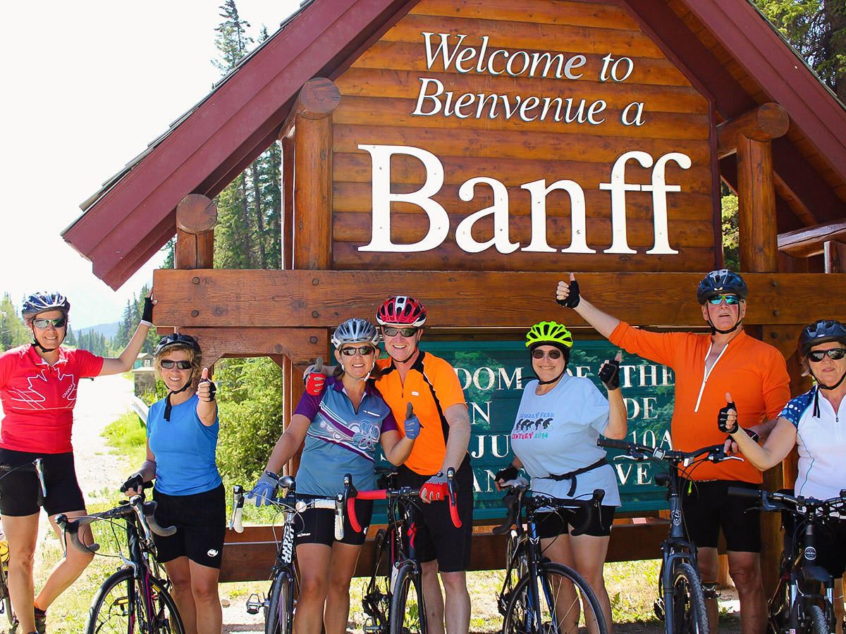 Group of bikers entering Banff on guided cycling tour from Jasper to Banff in Canada