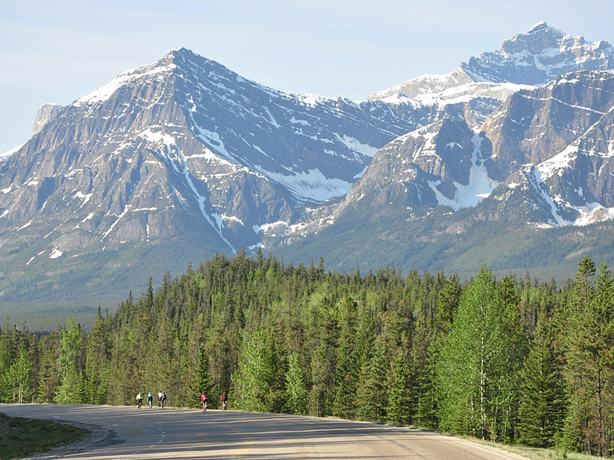 Riding among the beautiful mountains on guided cycling tour from Jasper to Banff in Canada