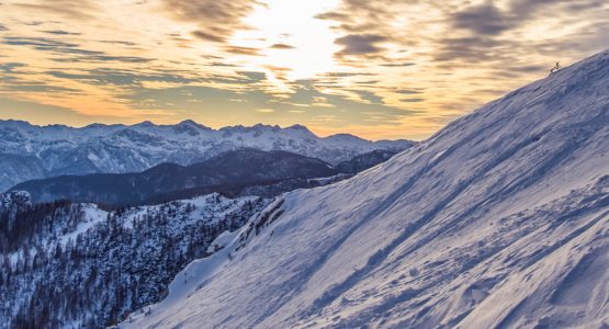 alpine mountain peaks with ski lines on the snow