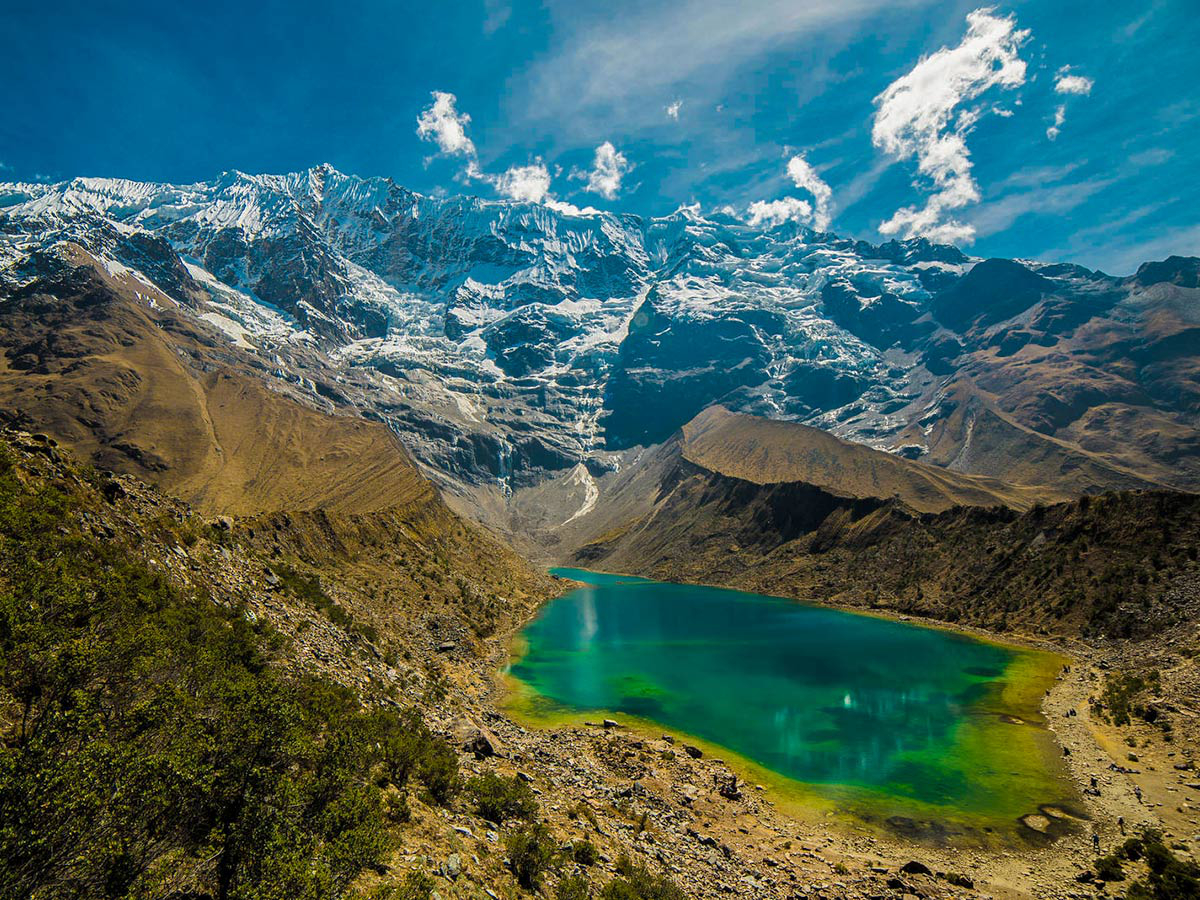 Turquoise lake glaciers and beautiful mountains on Salkantay Trek to Machu Picchu in Peru