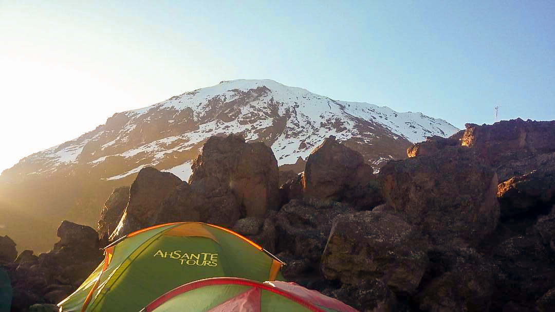 Mount Kilimanjaro above the tents on Kilimanjaro trek on Machame Route in Tanzania