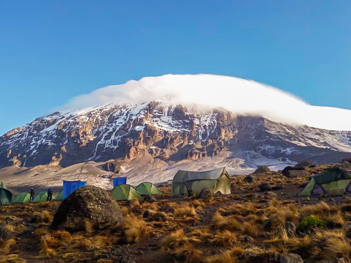 Tents in front of Kilimanjaro on Kilimanjaro trek on Machame Route in Tanzania