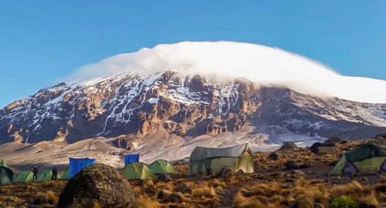 Tents in front of mount Kilimanjaro on Kilimanjaro trek on Machame Route in Tanzania