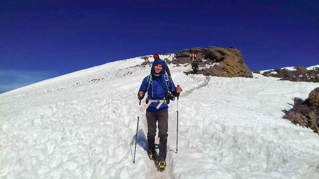 Hiker coming down off of Mount Kilimanjaro on Kilimanjaro trek on Machame Route in Tanzania