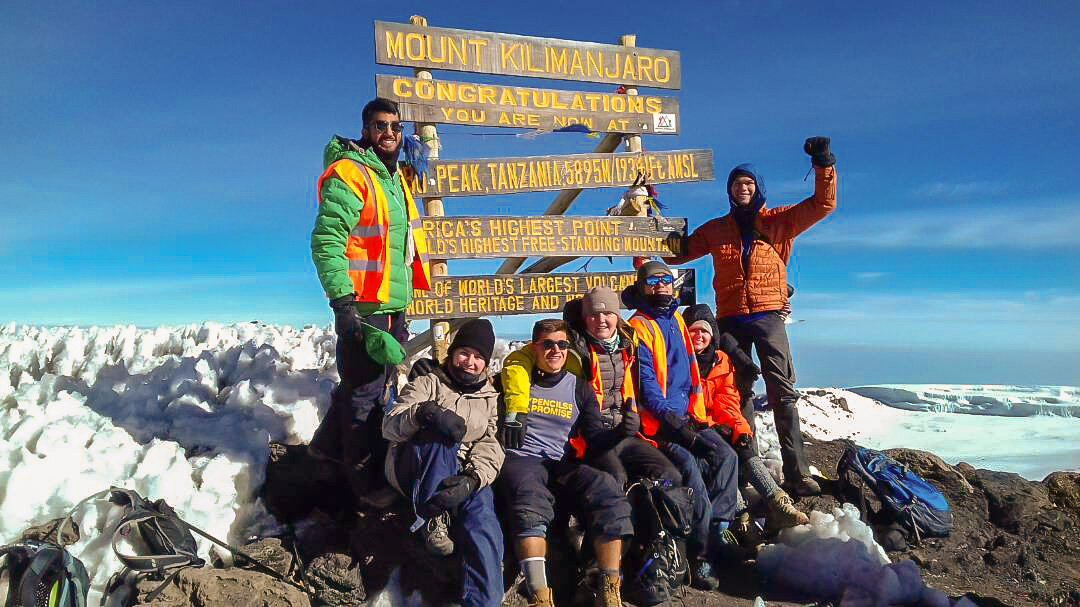 Happy climbers who have reached the top of Kilimanjaro trek on Machame Route in Tanzania