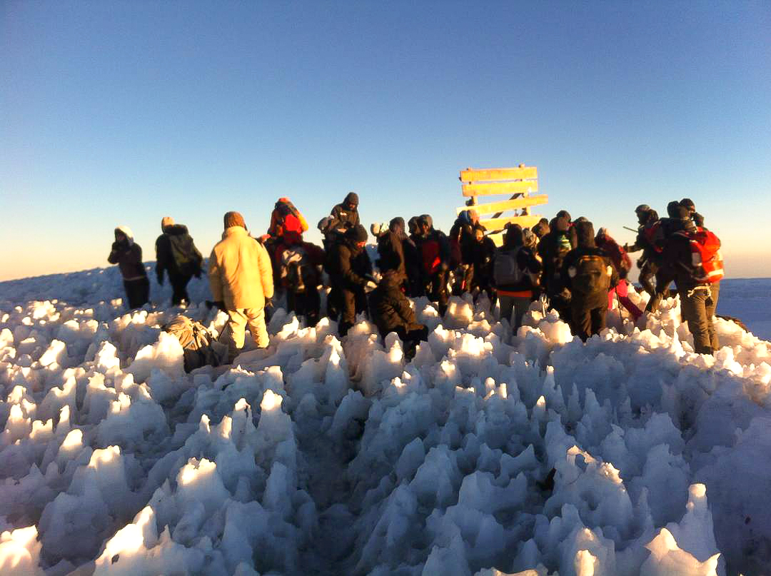 Group of hikers on top of Kilimanjaro trek on Machame Route in Tanzania