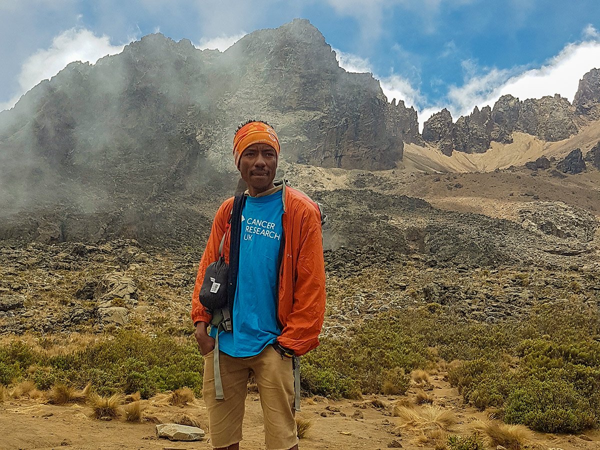 Hiker on guided Kilimanjaro trek on Lemosho Route in Tanzania