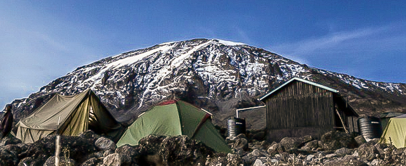 Tents in front of the peak on guided Kilimanjaro trek on Lemosho Route in Tanzania