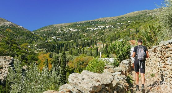 Hiker on stone path on Authentic Greek Islands hiking tour on Andros & Tinos