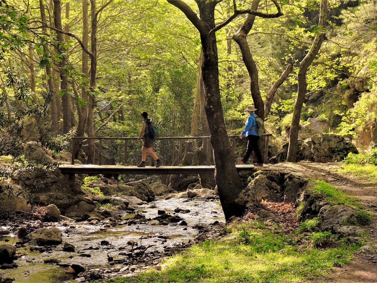 Crossing the river on guided trek in the White Mountains of Crete, Greece