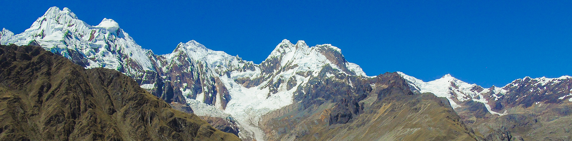 Panoramic view of white peaks along Alpamayo trek in Cordillera Blanca, Peru