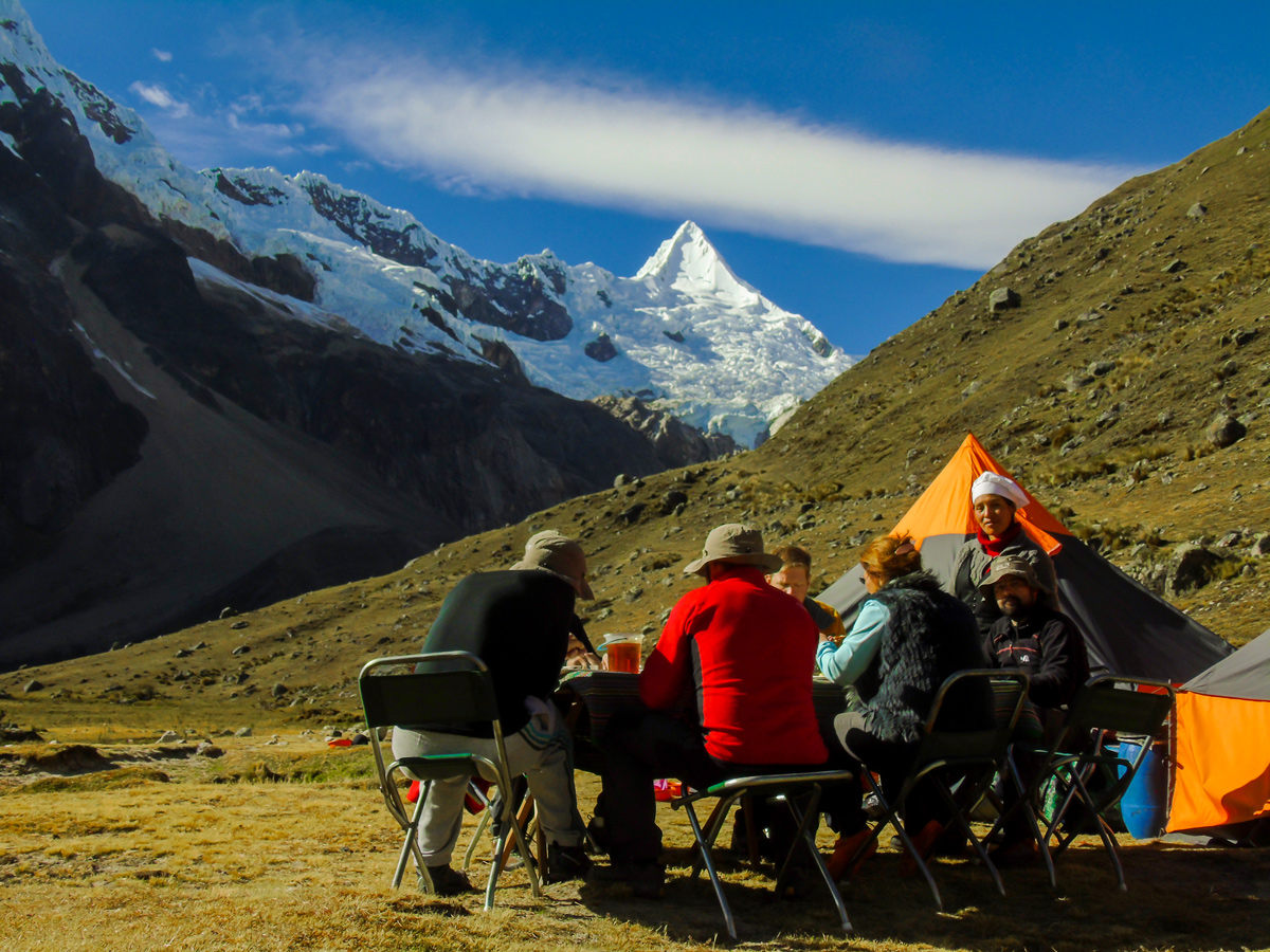 Having lunch with beautiful view on Alpamayo trek in Cordillera Blanca, Peru