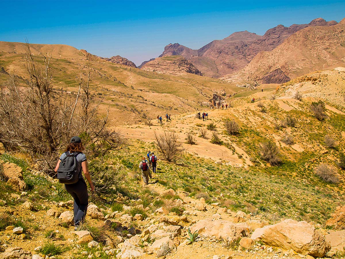 Group of hikers and beautiful views on Dana to Petra Trekking Tour in Jordan