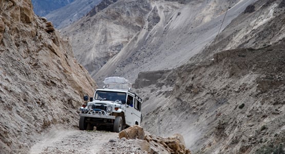 Jeep ride among the mountains on guided trekking tour to K2 Base Camp in Pakistan
