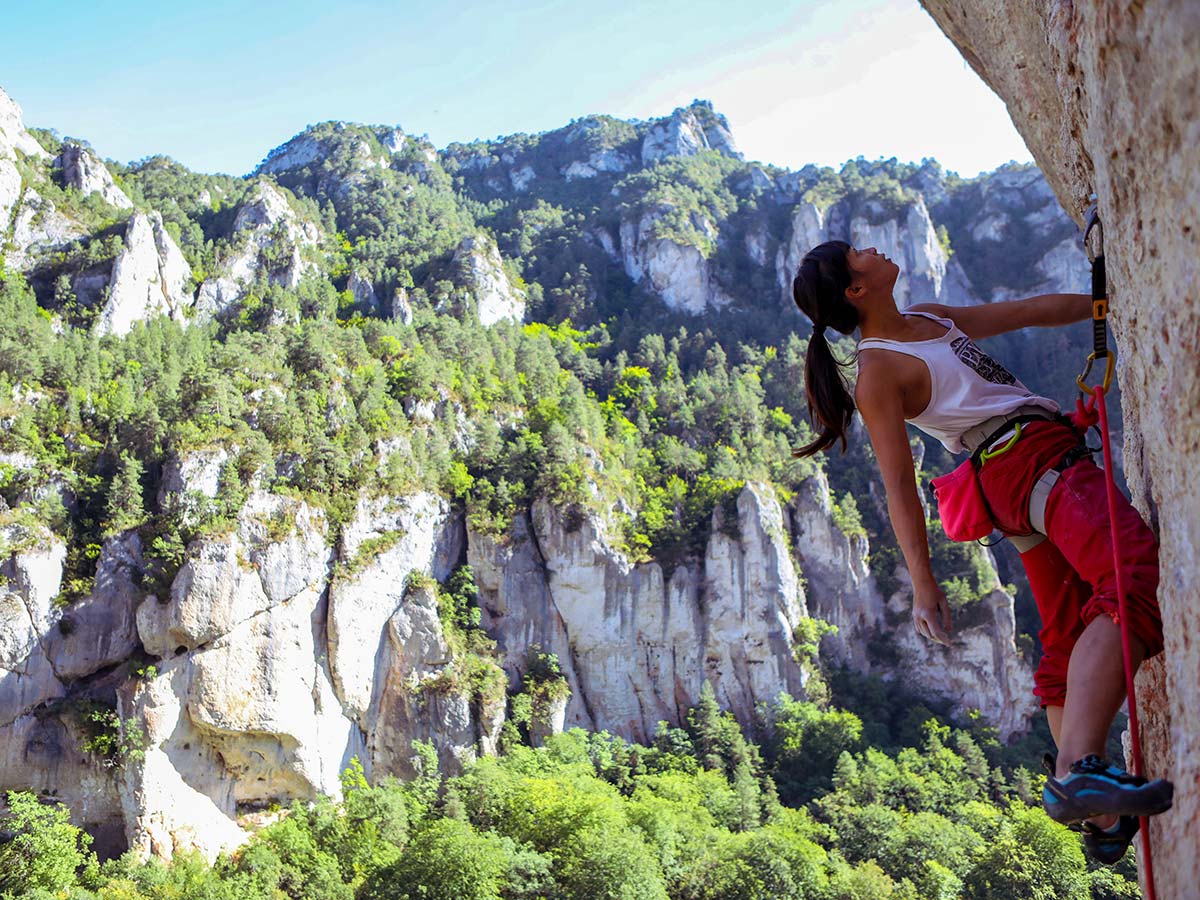 Climbing on rock wall on climbing camp at Gorges du Tarn in France