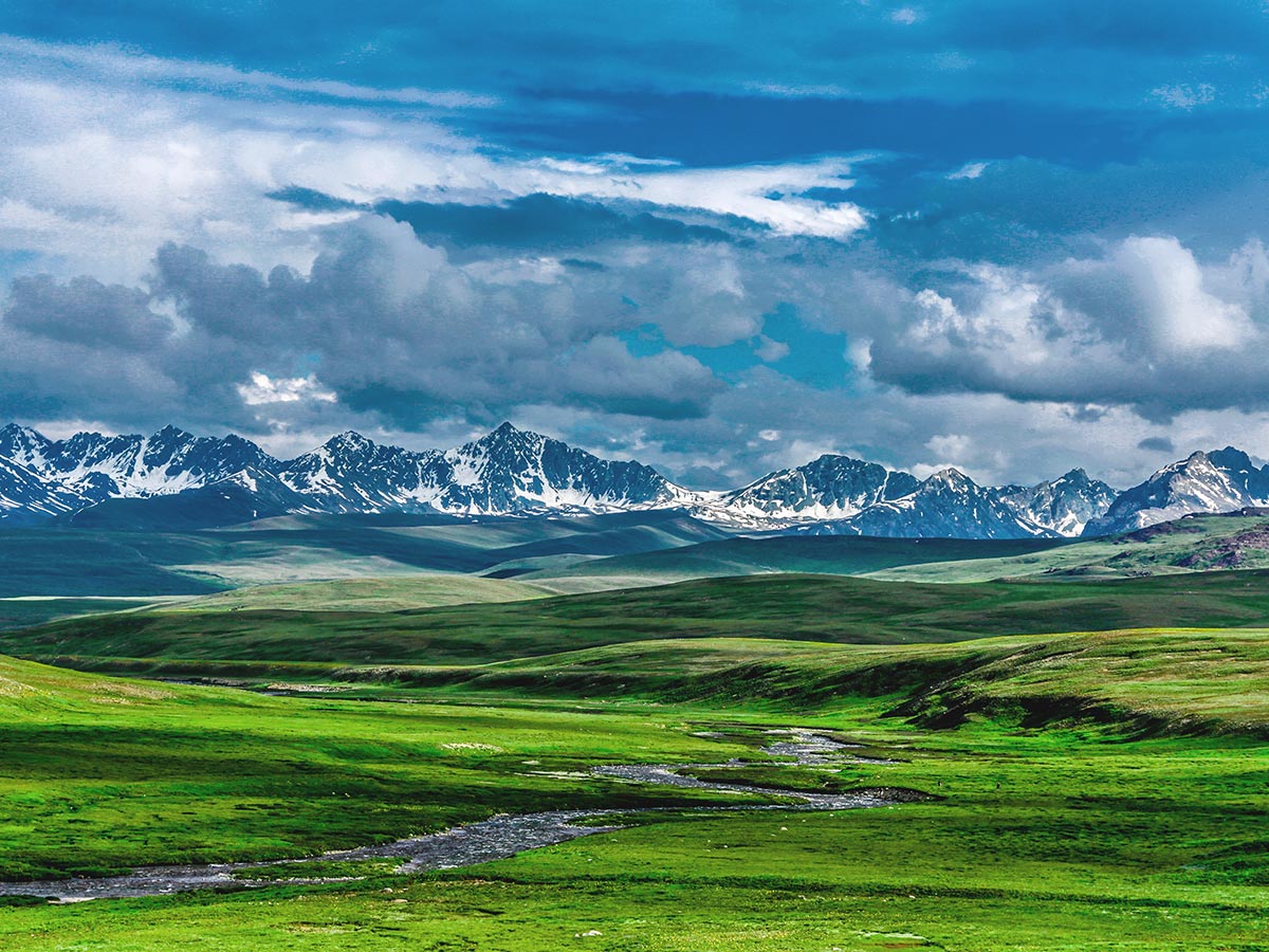 Looking to mountains over Deosai Plains on guided Overland Tour in Skardu Valley Pakistan