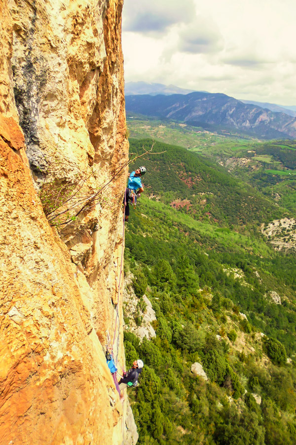Two men vertical climbing on Trad and Multipitch rock climbing tour in Riglos, Spain