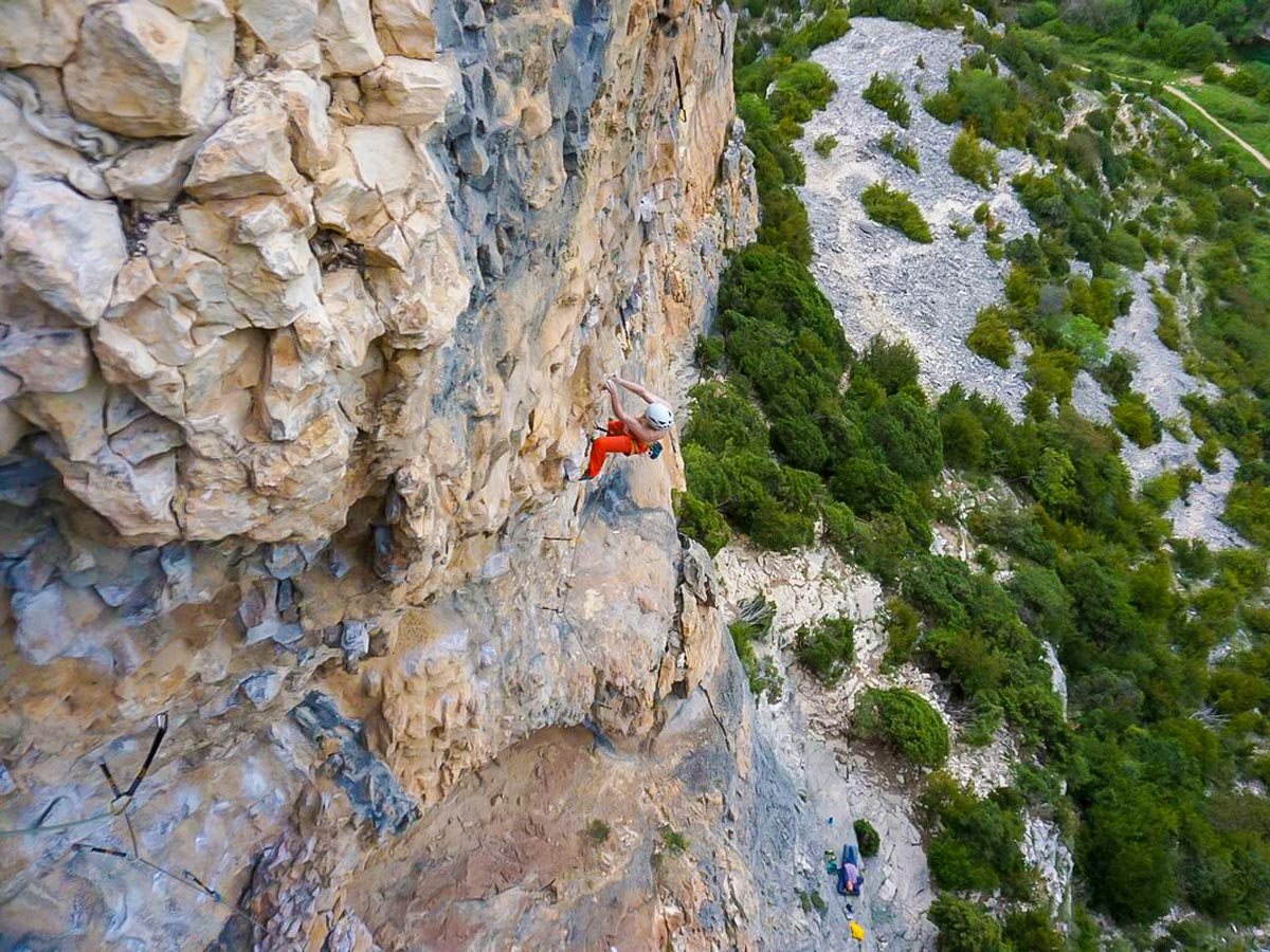 Ascending on rock wall in Rodellar on climbing tour