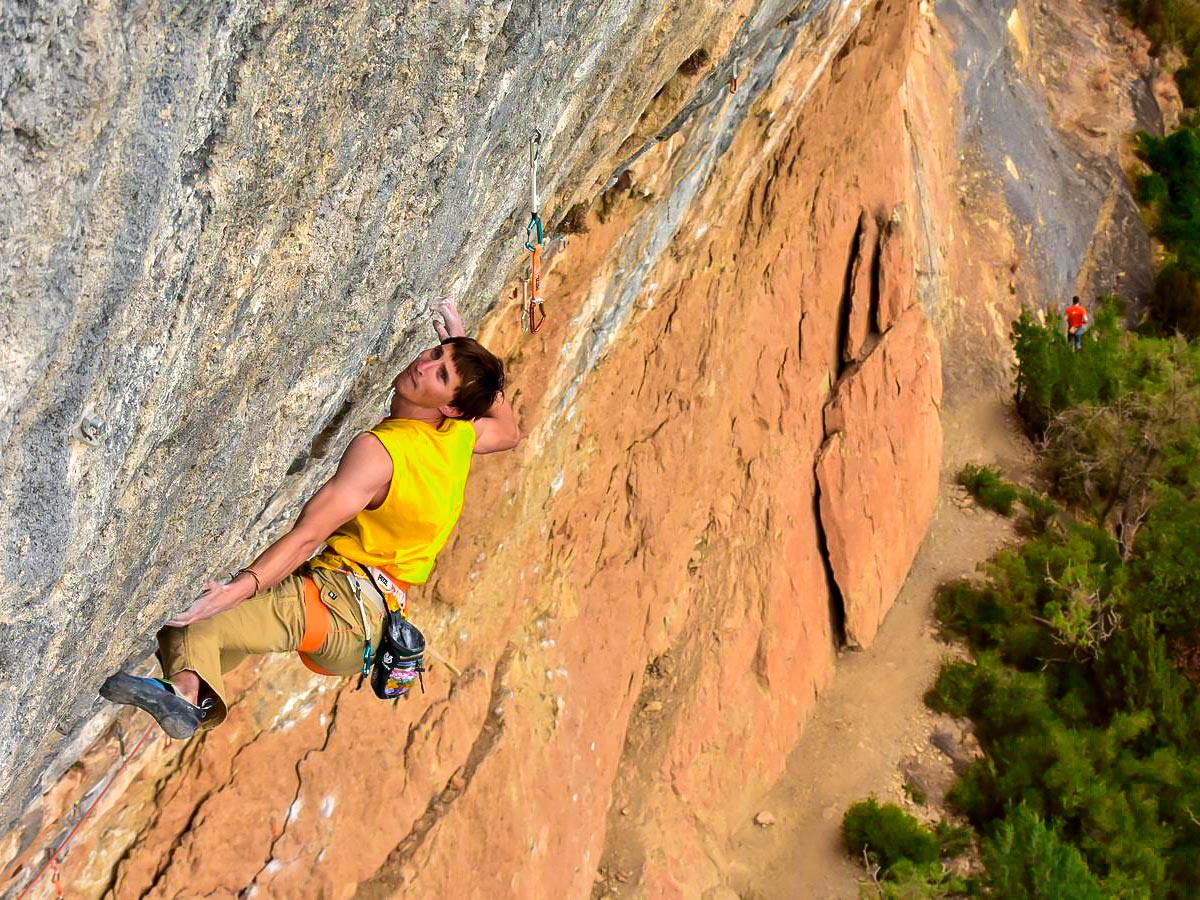 Rock climbing on vertical wall on rock climbing tour in Spain