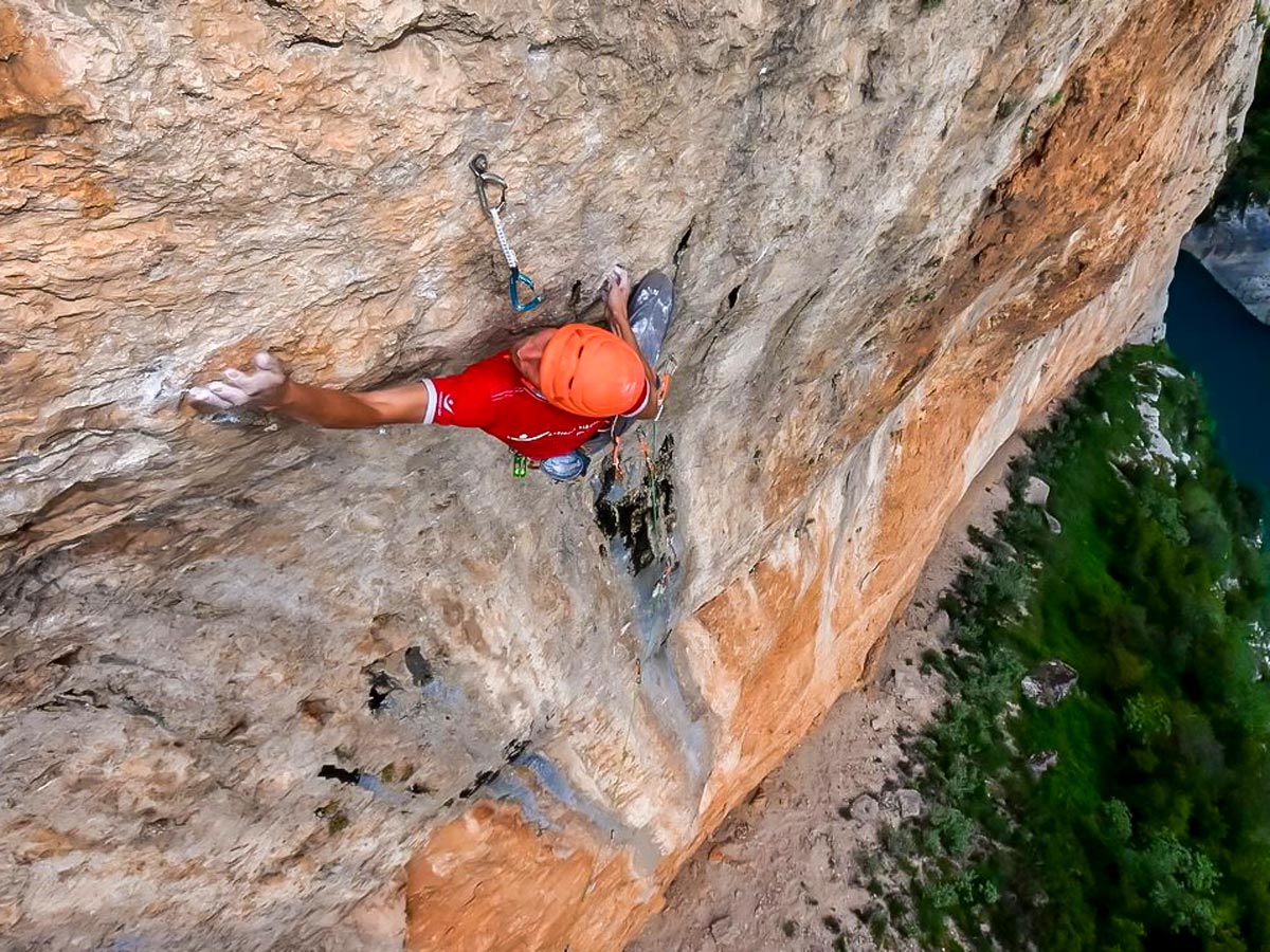 Climber on crag in Spain on rock climbing tour
