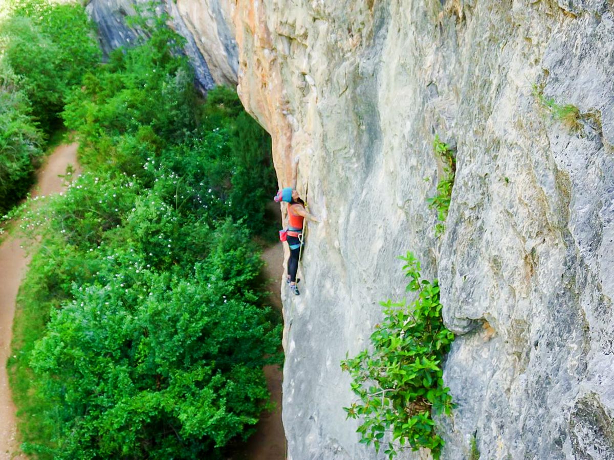 Woman climbing on crag on Women's climbing camp in Rodellar, Spain