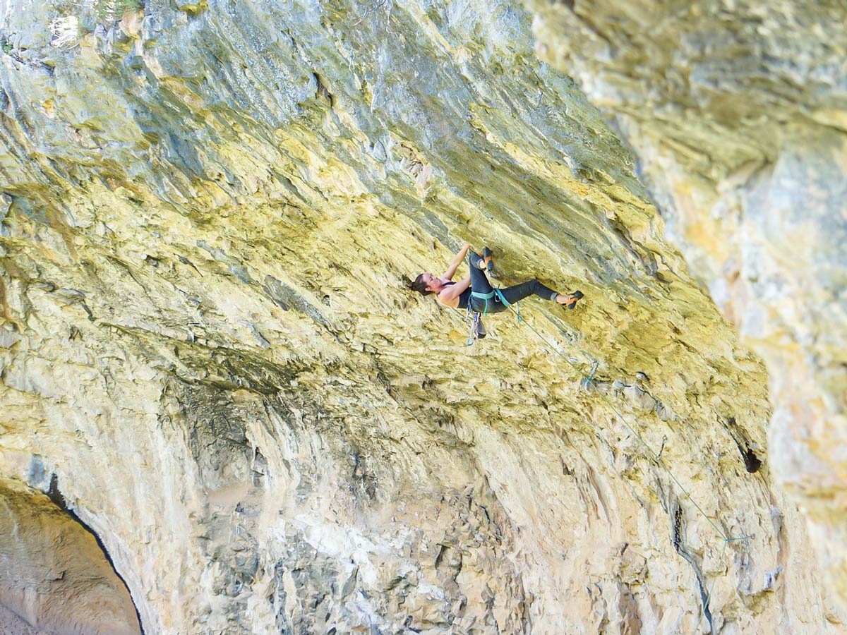 Woman climbing on rock in Rodellar on climbing camp for women in Spain