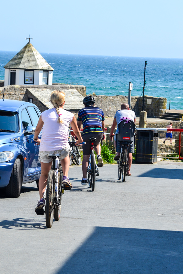 Cornwall family cycling towards harbour