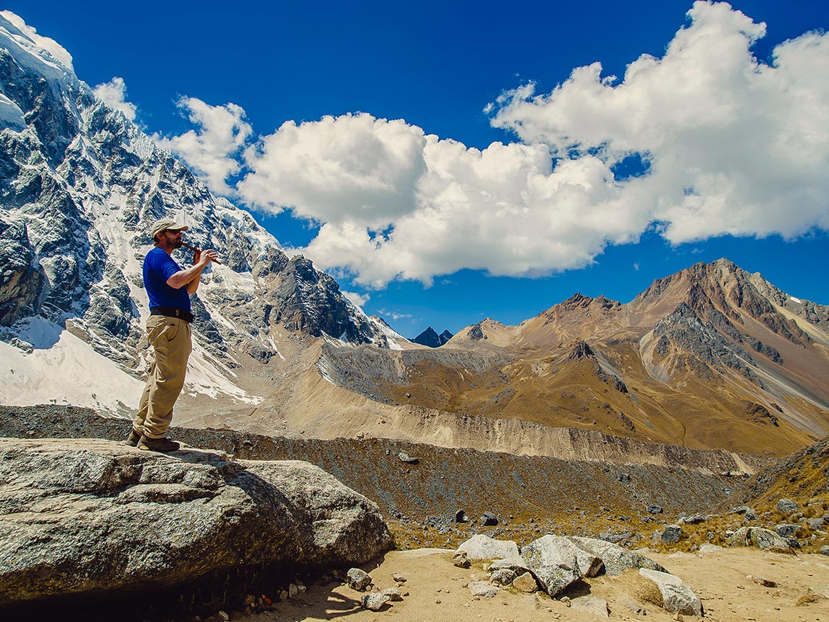 Hiker playing flute on Salkantay Trek to Machu Picchu in Peru