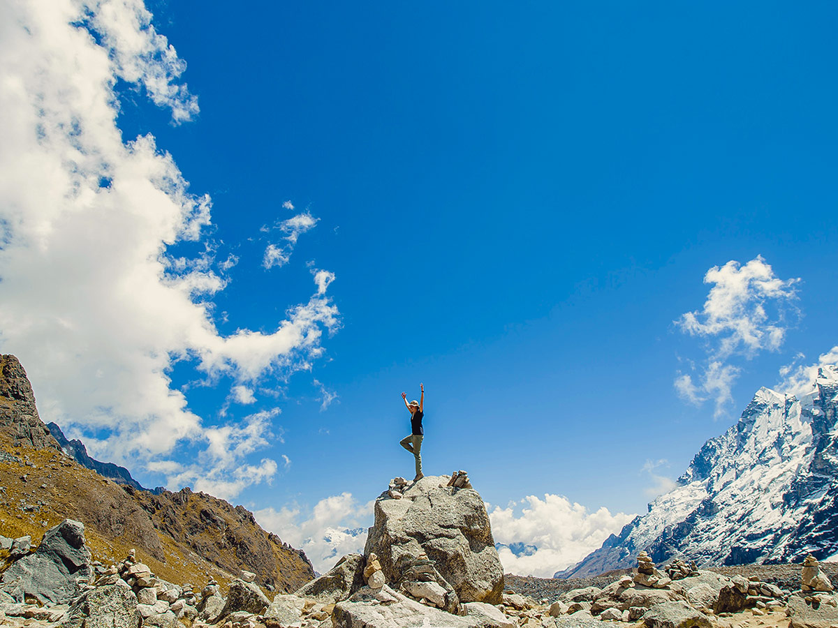 Streching on the big rock on Salkantay Trek to Machu Picchu in Peru