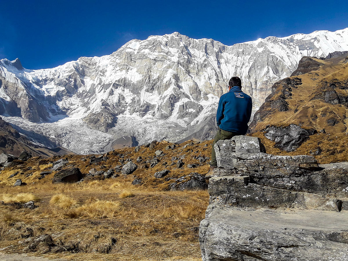 Porter on Annapurna Base Camp Guided Trek in Nepal observing beautiful Himalayan views