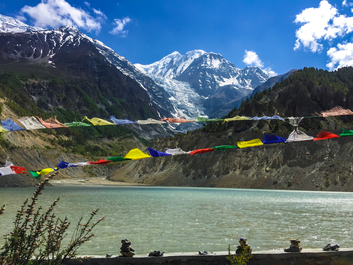 Prayer flags in front of the river on guided Annapurna Circuit hike in Nepal