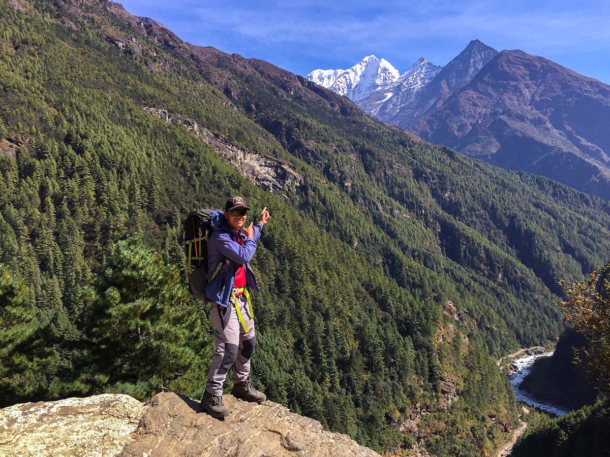 Hiker pointing to mountains on Annapurna and Everest Luxury Lodge Trek