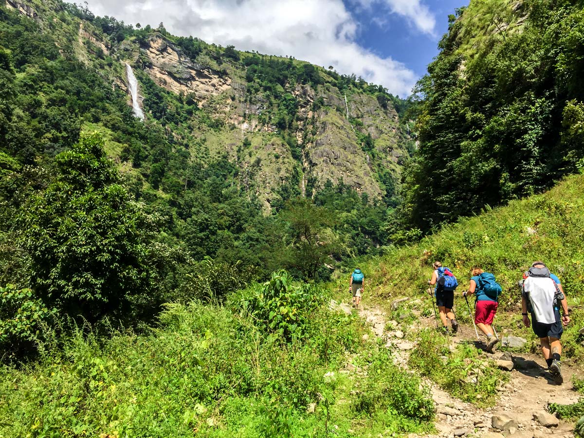 Group of hikers and waterfall on Manaslu Circuit trek in Nepal