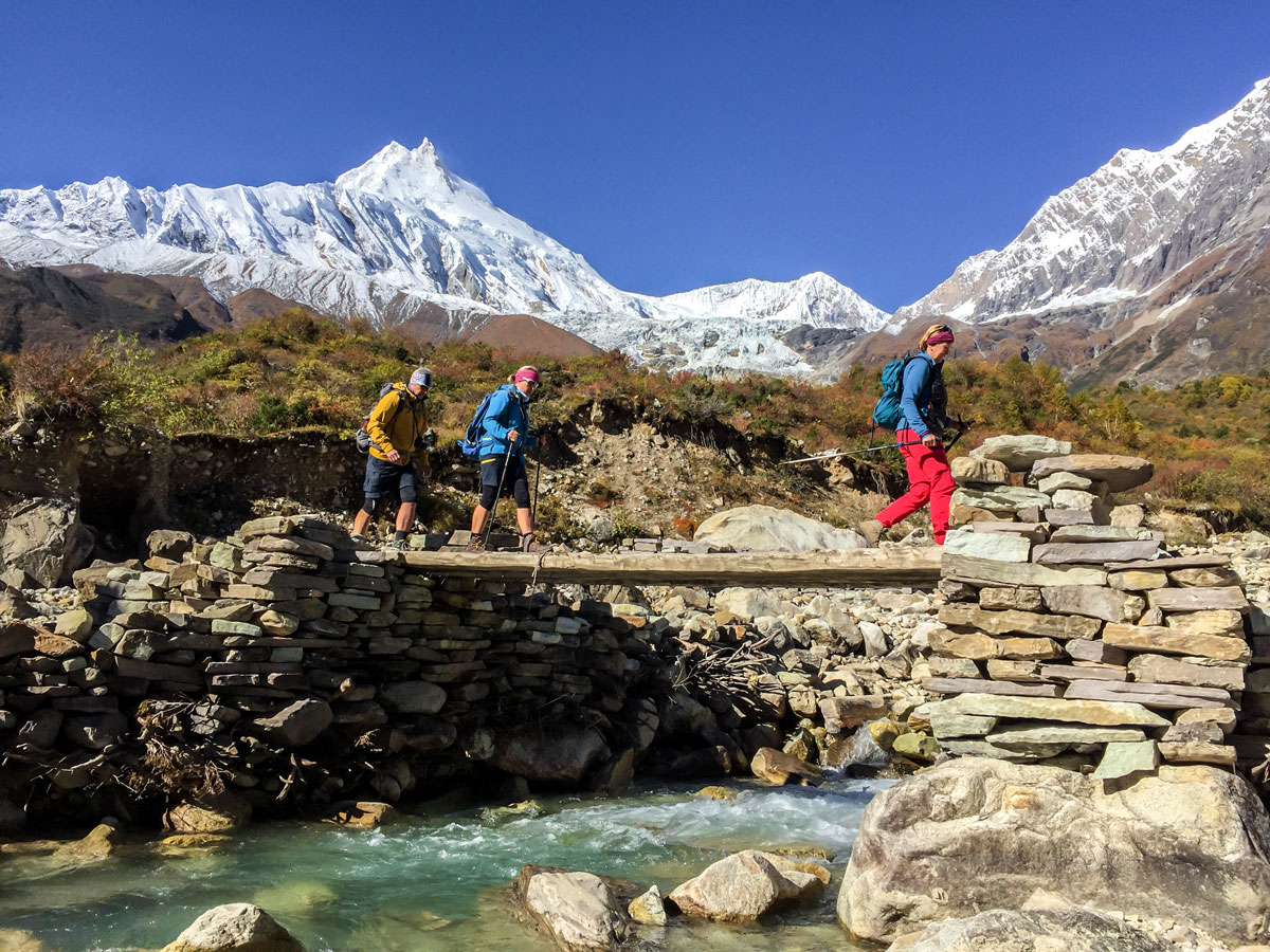 Crossing the river on Manaslu Circuit trek in Nepal