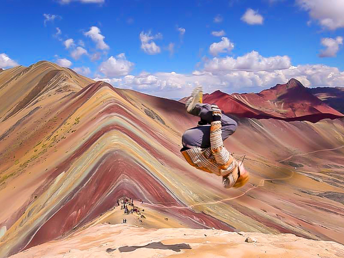 A person doing a flip on the Rainbow Mountains of Peru