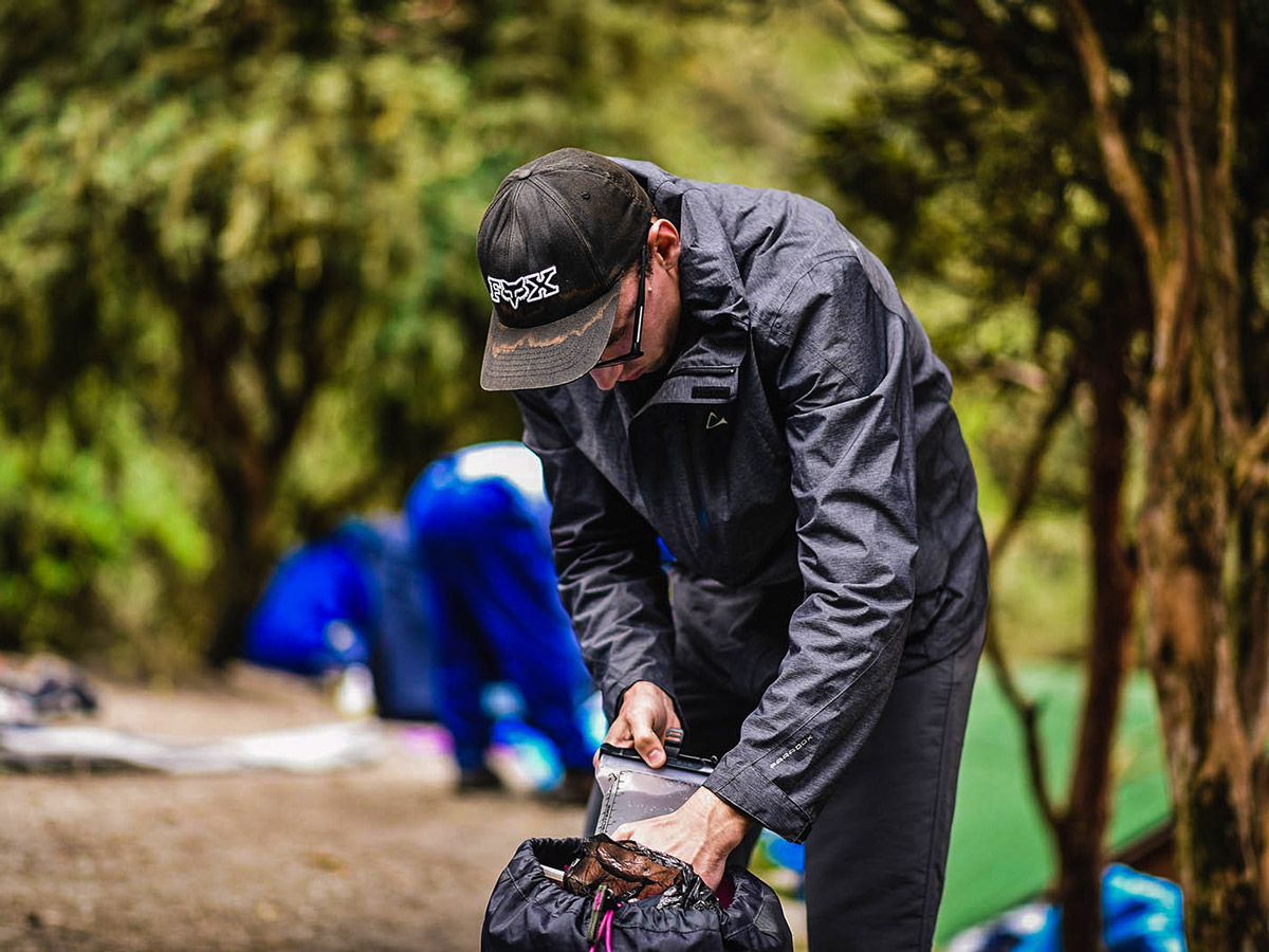 Hiker packing his stuff on Inca Trail to Machu Picchu near Cusco Peru