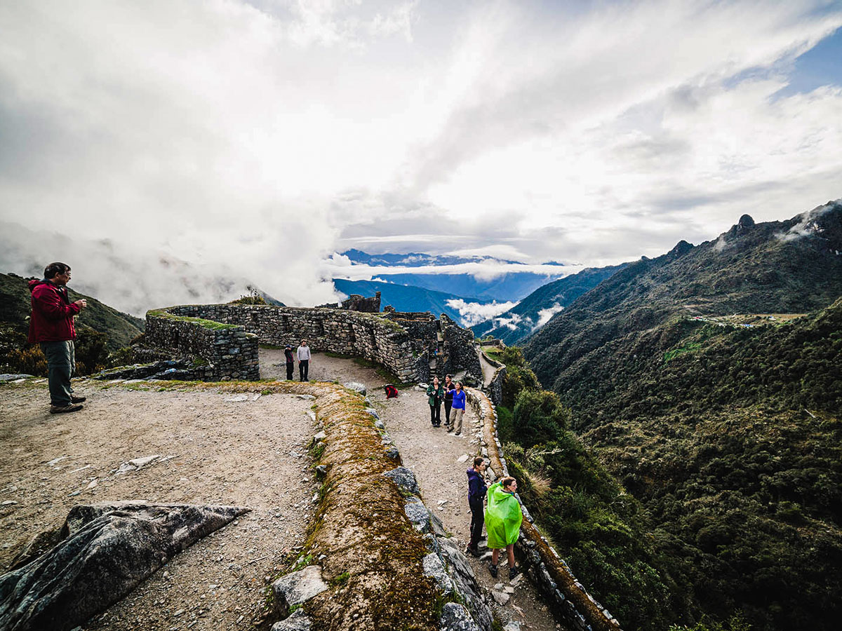 Hikers and Incan ruins on Inca Trail to Machu Picchu near Cusco Peru